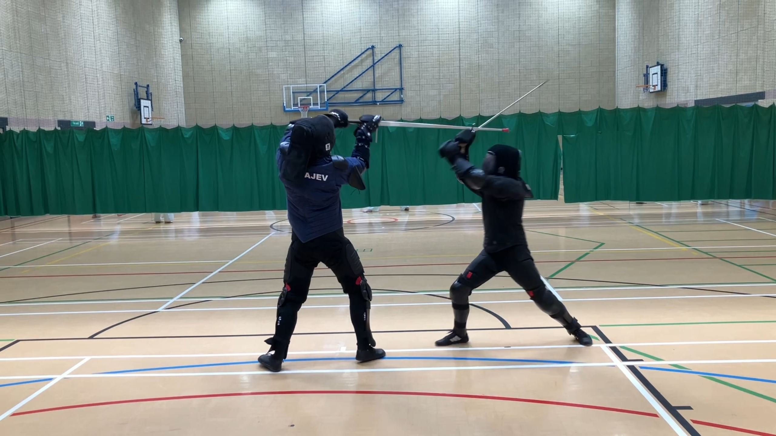 Two fencers sparring with metal longswords